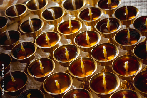 Buddhist Altar Candles at Religious 108 Butter Lamp Festival in Temple Monastery. Pouring Melted Butter Oil. Preparation process