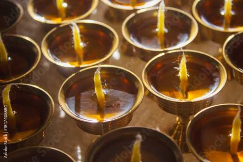 Buddhist Altar Candles at Religious 108 Butter Lamp Festival in Temple Monastery. Pouring Melted Butter Oil. Preparation process