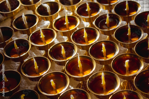 Buddhist Altar Candles at Religious 108 Butter Lamp Festival in Temple Monastery. Pouring Melted Butter Oil. Preparation process