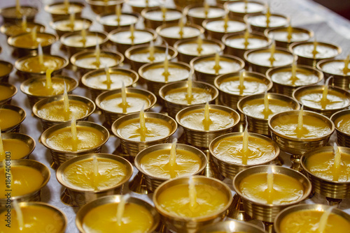 Buddhist Altar Candles at Religious 108 Butter Lamp Festival in Temple Monastery. Pouring Melted Butter Oil. Preparation process