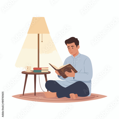 A man reads a book sitting on a rug under a lamp's light.