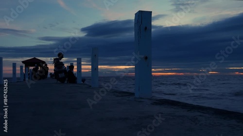 Time Lapse of Solitary Person Relaxing on Pier at Sunset - Peaceful Evening Contemplation by the Ocean