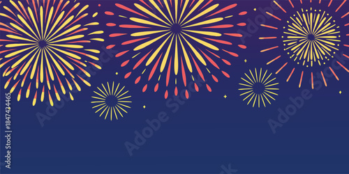 Celebratory fireworks display illuminates a dark night sky with vibrant explosions of yellow and red light, creating a festive atmosphere for holidays and special events.