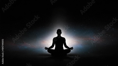 Silhouette of a person meditating in the cosmos with a gentle light emanating from within