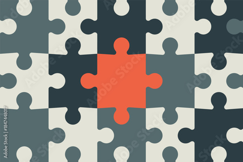 A single orange puzzle piece stands out amongst grey and white pieces.