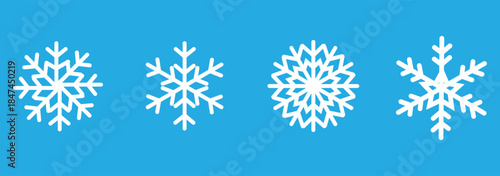 Collection of four snowflake icons in different graphic styles including line art, outline, and solid color silhouettes for winter holiday and weather