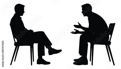 Two silhouetted men sit on chairs and converse with each other.