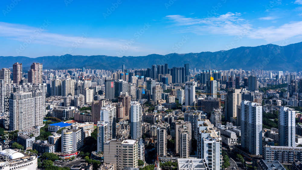 Fototapeta premium Urban Skyline with Modern Skyscrapers and Mountains