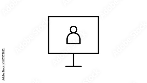 A computer monitor shows a person, who is seated and interacting with the device in a work environment.