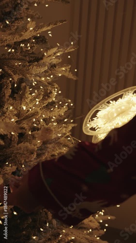 Decorating Christmas Tree with Warm Fairy Lights at Home