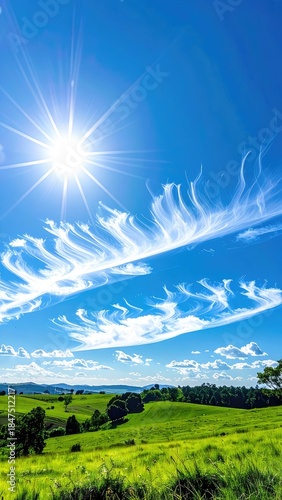 Wallpaper Mural Vibrant sun flares over rolling green hills under a vivid blue sky with striking cirrus clouds. Torontodigital.ca