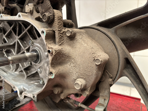 Close-up of Dirty motorcycle transmission housing with dust and grime on engine components during repair and maintenance