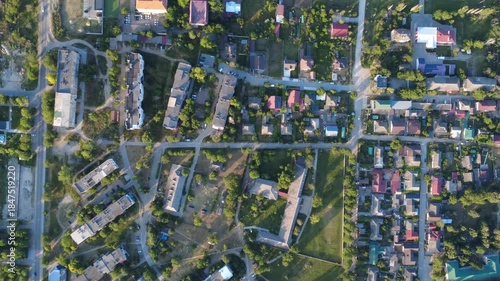 flying a drone above river in small town