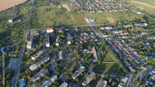 flying a drone above river in small town