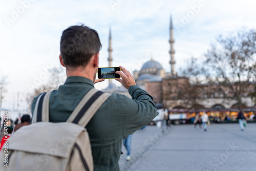 Traveler capturing Istanbul architecture with smartphone during city trip