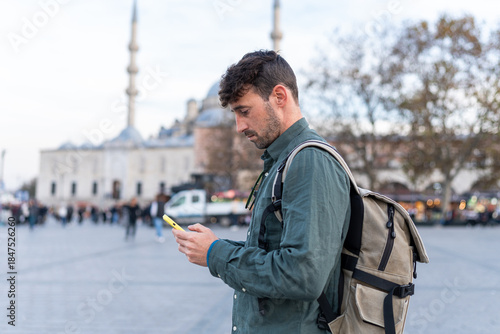 Billede på lærred Traveler consulting smartphone in Istanbul looking for directions