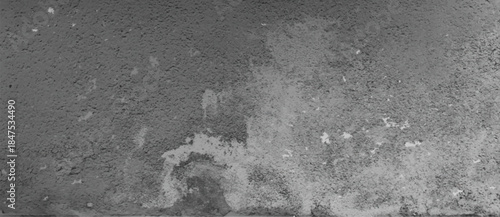 Rustic concrete wall texture with rough stone surface and weathered cement pattern in gray color. Grunge background with scratches and aged industrial material for architectural or vintage design.