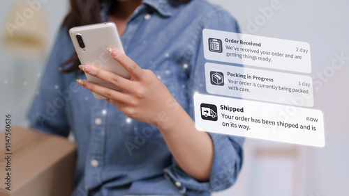 Obraz na plátně Asian adult woman customer checks online order status on smartphone receiving de