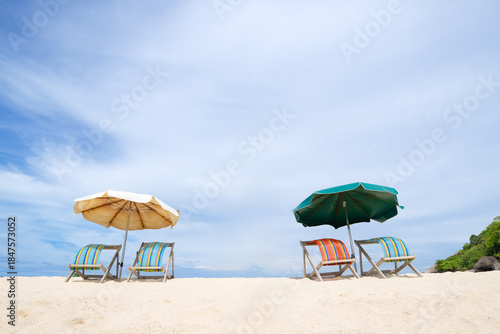 Colorful Loungers and umbrellas on a sandy shoreline, with bright skies, tropical atmosphere, and serene beaches — perfect for tourism brochures, vacation advertisements, and destination marketing.