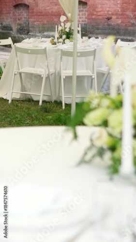 A very beautiful and stylish banquet table with a tent outdoors. Wedding decor and floral arrangements before the ceremony and celebration