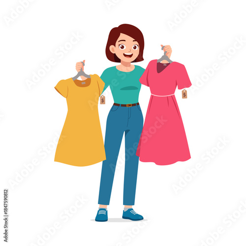 Smiling young woman holding two dresses yellow and pink with price tags making a choice while shopping