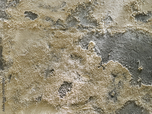 Rough textured background of an old weathered and crumbling plaster wall.