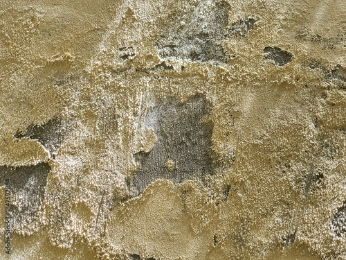Detailed close up of a weathered and crumbling ancient stone wall surface.