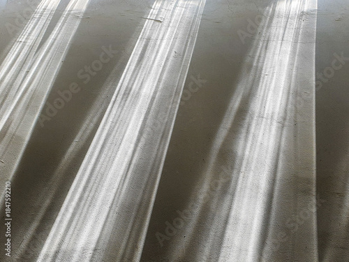 Abstract background of brushed metal texture with diagonal lines and light reflections.