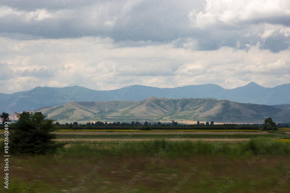 Fototapeta premium Mountain,field and dramatic sky