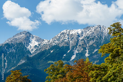 Snow-Capped Mountains and Forest Landscape Under Blue Sky