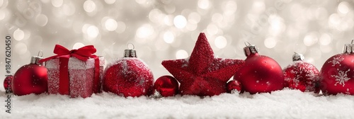 Festive Red Ornaments on Snow with Sparkling Bokeh Background