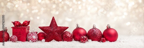 Festive Red Ornaments on Snow with Sparkling Bokeh Background