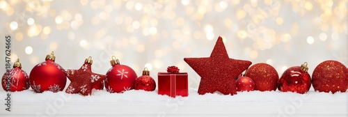 Festive Red Ornaments on Snow with Sparkling Bokeh Background