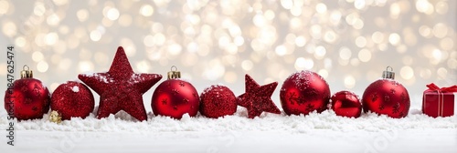 Festive Red Ornaments on Snow with Sparkling Bokeh Background
