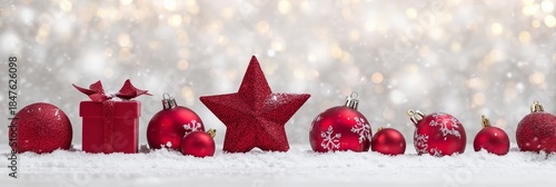Festive Red Ornaments on Snow with Sparkling Bokeh Background