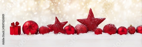 Festive Red Ornaments on Snow with Sparkling Bokeh Background