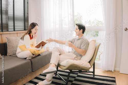 Happy Asian couple enjoying time together in their new home