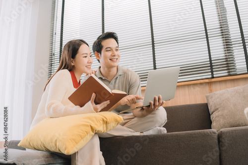 Happy Asian couple enjoying time together in their new home