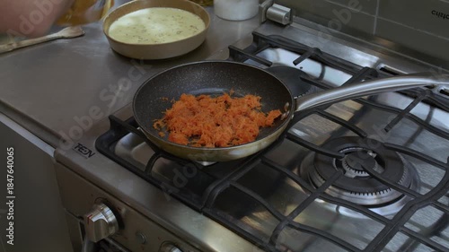 Cook preparing something in a pan