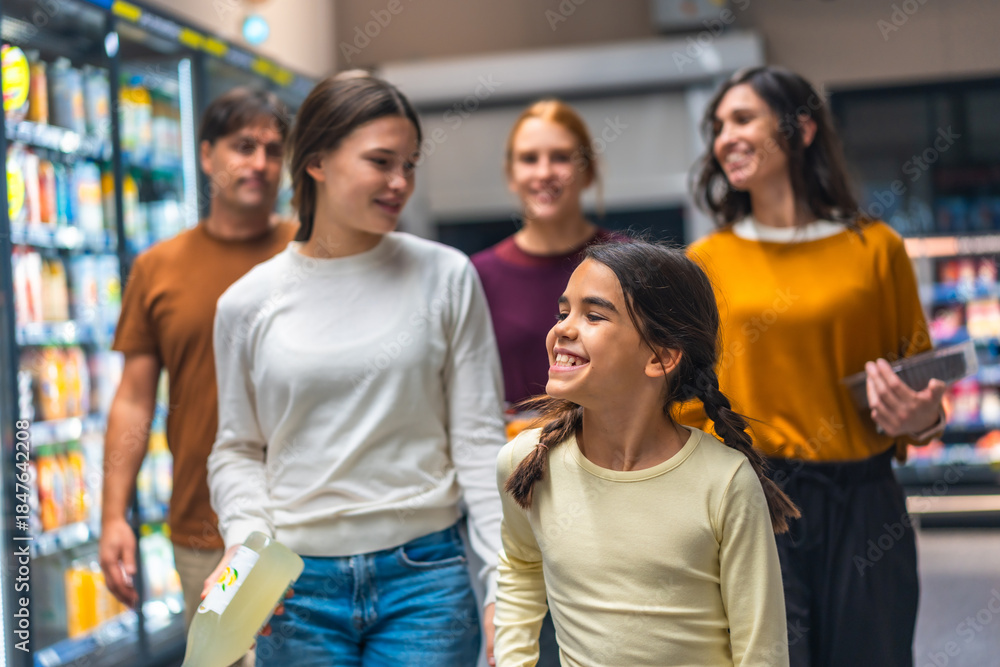 Obraz premium Family shopping for groceries together enjoying supermarket aisle