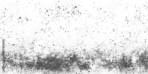 Dark grey speckle texture on white background with dense bottom area and scattered dots above grunge