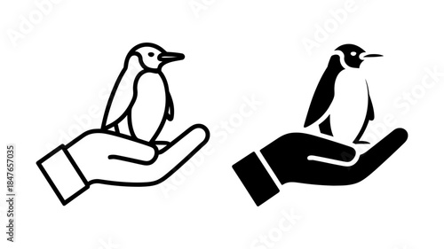 Hand holding a small penguin icon, symbolizing animal care and wildlife conservation