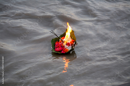 red candle on the water