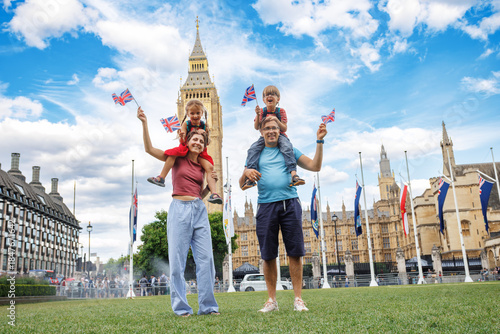 Photography Happy family travelers holding British flags near Big Ben site