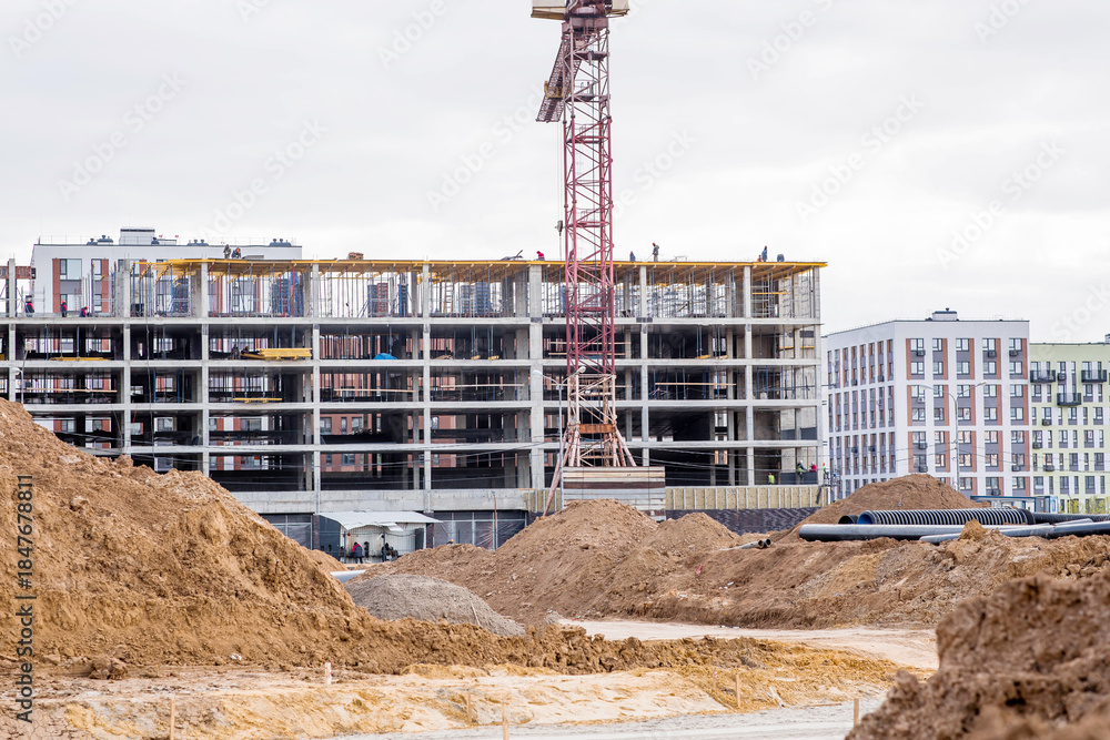 Fototapeta premium Construction of new residential areas. Construction tower crane on a sunny day. New buildings. Vidnoye, Leninsky District, Moscow Region.