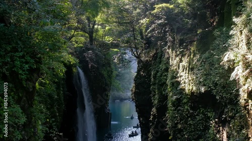 Takachiho Gorge in Takachiho, Miyazaki, Kyushu, Japan, Waterfall flowing into river between rocky cliffs in forest nature landscape