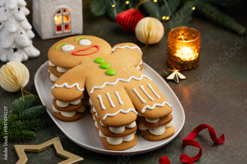 Honey cake christmas gingerbread man on a white plate. New year festive dessert. Selective focus