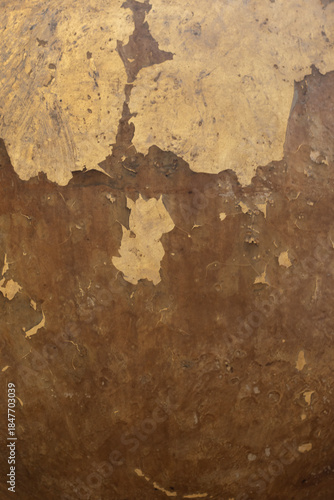 The old wall surface is rough and has abstract vintage golden cracks.