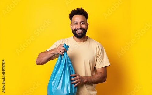 Man in t-shirt volunteer hold trash bag isolated on yellow background. Voluntary free assistance help charity grace. Environmental pollution problem. Stop nature garbage environment protection concept