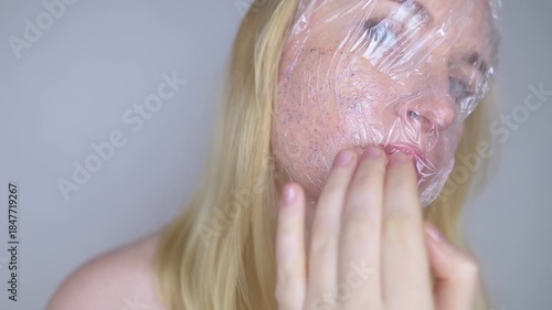 Microplastics in cosmetics. A woman applied a care cream to her skin, now it is covered with plastic particles and microbeads. Cosmetics toxicity concept